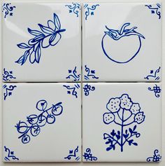 four blue and white tiles with flowers and fruit on them, all in different designs