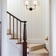 an entry way with stairs and two lamps