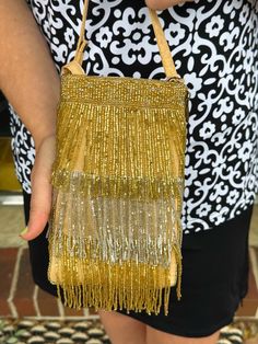 This bag contains a 54" crossbody strap that can be tucked away when not in use. This purse can be used as a crossbody or a wristlet purse! A short strap that unsnaps so the bag can be attached to a larger bag or belt, and a separate, secure side zip pocket for cash and credit cards. Size: 4.5"W x 7.5"H Hand beaded by artisans in India, this versatile smart phone bag can be worn cross body or as a wristlet. Evening Clutch With Cell Phone Pocket, Evening Crossbody Bag With Cell Phone Pocket, Evening Handheld Phone Bag With Adjustable Strap, Evening Shoulder Phone Bag With Cell Phone Pocket, Elegant Adjustable Crossbody Bag, Gold Evening Bag With Cell Phone Pocket, Evening Crossbody Phone Bag With Cell Phone Pocket, Rectangular Phone Bag With Adjustable Strap For Evening, Evening Phone Bag Satchel With Adjustable Strap