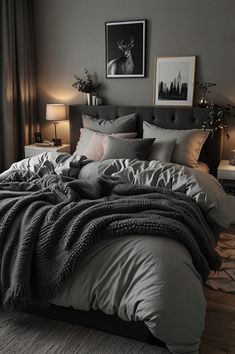 a large bed sitting in a bedroom next to two lamps and pictures on the wall