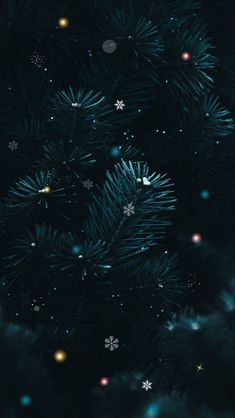 a christmas tree with snowflakes and stars in the night sky, as seen from above