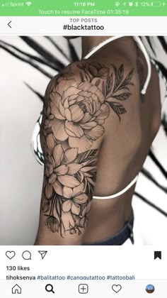 the back of a woman's arm with flowers on it