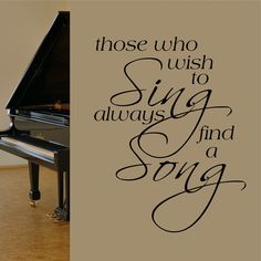 there is a wall decal that says those who wish to sing and find a song