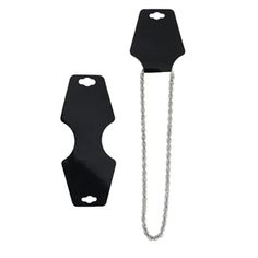 two black metal objects with chains attached to each other on a white background, one has a chain hanging from it