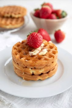 a stack of waffles with strawberries on top