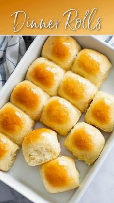 rolls in a white baking dish with the words dinner rolls written on top and below