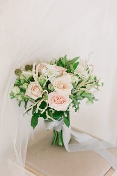 a bouquet of flowers sitting on top of a book