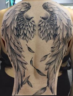 the back of a man's body with two large wings on his upper half