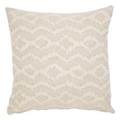 a beige and white pillow with an intricate pattern on the front, sitting on a white background