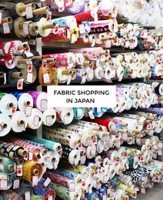 many rolls of fabric are on display with the words fabric shopping in japan