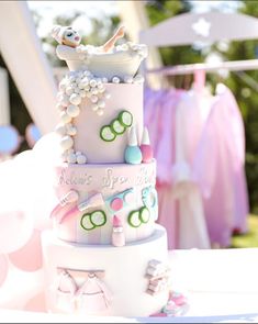 a three tiered cake is decorated with pearls and other things on it's side