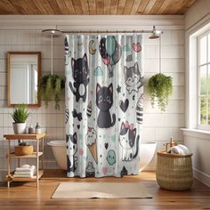 a bathroom with a cat shower curtain next to a bathtub and toilet in it