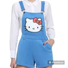 Hello Kitty Blue Shortalls Channel Your Favorite Sanrio Character With These Blue Shortalls Featuring Hello Kitty's Face On The Bib And Her Signature Bow On The Back Pocket. Adjustable Straps. Shell: 97% Polyester; 3% Spandex Contrast 1: 97% Cotton; 3% Spandex Contrast 2: 100% Polyester Lining: 100% Polyester Listed In Junior Sizes Large Please See Picture For Measurements **Please See The Last Picture, I Did Notice Two Scratch In The Shorts** New With Tags Hello Kitty Pants, Vintage Overalls, 3 Picture, Blue Y2k, Linen Romper, Pink Hello Kitty, Pink Cat, Pajama Bottoms, Sanrio Characters