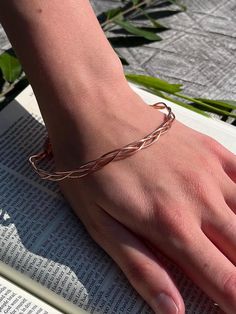 18-gauge 100% pure copper three piece dainty braided bangle bracelet.  Lightweight and comfortable design with delicate features. When exposed to the elements this metal shows colorful variations. Coppers thermal and electrical conductive qualities heighten your ability during spiritual practice of prayer and meditation. Due to this bracelet's delicate nature, be mindful not to bend. Bangle length is 9 inches. Comfortably fits up to 8 inch wrist Please keep in mind Copper naturally ages over time.  The patina of this piece will add to it's unique beauty! 🤎All of my jewelry is handmade and nonrefundable.  I encourage you to reach out with any questions if you are unsure about a piece! I am more than happy to answer and send additional pictures etc.  I cannot allow refunds due to a number o Adjustable Copper Wire Bangle, Adjustable Copper Wire Bangle Bracelet, Adjustable Copper Bohemian Braided Bracelet, Adjustable Copper Braided Bohemian Bracelet, Adjustable Bohemian Copper Braided Bracelet, Copper Braided Bangle Bracelet Gift, Adjustable Braided Bangle Jewelry, Adjustable Rose Gold Braided Bracelets, Adjustable Rose Gold Braided Bracelet