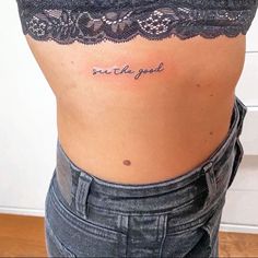 a woman's lower back tattoo with the words sweet the good written in cursive font