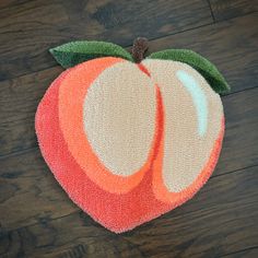 an apple shaped rug is on the floor