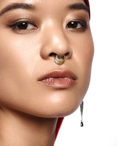 a woman with a nose ring and piercing on her nose