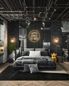 an industrial style bedroom with black and white decor, wood flooring and exposed lighting