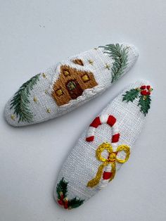 two white christmas slippers with gingerbread house and candy canes on the bottom