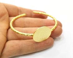 Material Wrist strap : Brass Blank : zinc alloy Color: Gold Blank Size : 25mm Blanks Quantity : 1 pc. To see other all Gold Bracelet Blanks please click below https://www.etsy.com/shop/AZsupplies/search?search_query=bracelet+blank+gold&order=date_desc&view_type=list&ref=shop_search To see other all Gold Ring Blanks please click below https://www.etsy.com/shop/AZsupplies/search?search_query=nice+gold+ring+blank&order=date_desc&view_type=list&ref=shop_search To see other al Metal Circle Bracelets As Gift, Metal Bracelets As Gift, Metal Bracelets Gift, Hammered Metal Bracelets, Adjustable Gold Round Cuff Bracelet, Adjustable Brass Bangle, Gold Nickel-free Round Cuff Bracelet, Adjustable Gold Circle Bracelets, Adjustable Circular Gold Bracelet