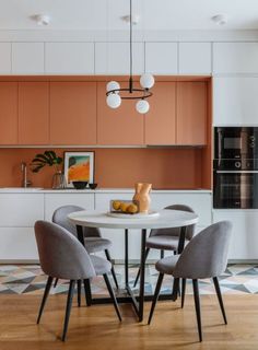 a dining room table with four chairs around it