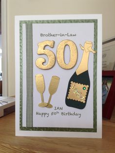 a 50th birthday card with the number 50 on it, and a bottle of wine