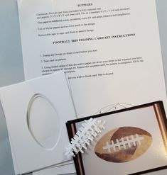 a football card with an ornament next to it on top of some paper