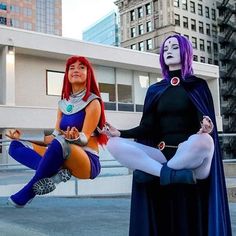 two women dressed in costumes pose for the camera while one woman holds her leg up