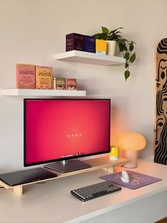 A minimalist and cozy home office setup featuring a large monitor on a sleek desk, surrounded by vibrantly colored decor items including books, a plant, and an artistic skateboard on the wall. The workspace is characterized by its clean design and pops of color that create a lively and inspiring environment. Cozy Setup, Lighting Hacks, Indian Room, Lighting Tips, Aesthetic Space, Warm Lighting