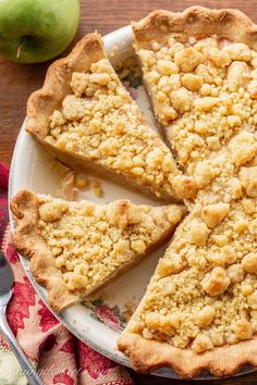 an apple pie is cut into slices on a plate