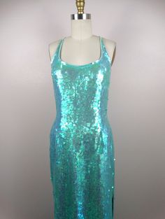 "This is a JAW-DROPPING vintage gown! It's fully embellished with iridescent sequins and in perfect condition! Measurements: Bust - 34\" Waist - 27\" Hips - 36\" Length - 59\" This item comes from a pet-free and smoke-free home. If you would like more info or have any questions, please don't hesitate to ask!" Embellished Mermaid Evening Dress, Night Out Mermaid Sequin Evening Dress, Fitted Embellished Mermaid Evening Dress, Glamorous Sleeveless Sequin Mermaid Dress, Fitted Embellished Mermaid Dresses, Glamorous Sequin Dress With Mermaid Hem, Glamorous Mermaid Sequin Evening Dress, Iridescent Sequin Dresses For Party Season, Sequin Mermaid Dress For Party Season