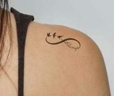 the back of a woman's shoulder with an arrow tattoo on her left arm