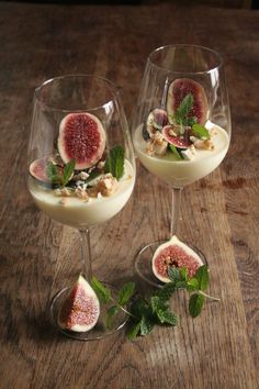 two wine glasses filled with dessert and fruit