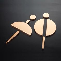 two pieces of wood sitting next to each other on a black surface with one piece cut out