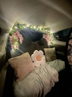 a bed with flowers and lights on the headboard