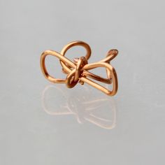 "This unique bow ear cuff is handmade using copper, sterling silver, or 14k gold filled. Free Us shipping. Customers who purchased this item said: \"Loved this cuff so much. I lost it the first day I wore it, but got many compliments before that happened. Great store! \" The price include one piece of the ear cuff. If you need a pair, please order two pieces. ;-) Enter my shop here: http://www.etsy.com/shop/AniDesignsllc?ref=pr_shop_more ;-) My contact number: 626-379-1904. Please contact me if Gold Wire Wrapped Ear Cuff As Gift, Handmade Copper Wrap Earrings For Gift, Rose Gold Single Earring Ear Cuff As Gift, Rose Gold Single Ear Cuff As Gift, Copper Wrap Earrings For Pierced Ears As Gift, Copper Wrap Earrings With Ear Wire As Gift, Unique Ear Cuff As Gift With Ear Wire, Handmade Rose Gold Wrap Earrings, Handmade Rose Gold Wrap Earrings Gift