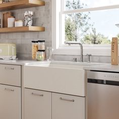 a kitchen with white cabinets and open shelves