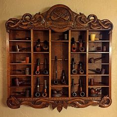 a wooden shelf filled with lots of different types of tools on top of a wall