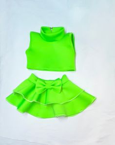 Neon green mock turtle neck crop top with double circle skirt pageant girls neoprene casual wear DUE TO THE NATURE OF THIS BEING A HANDMADE ITEM, NO REFUNDS OR EXCHANGES ON OUR ITEMS. PLEASE ENSURE YOU MEASURE YOUR CHILD FOR THE CORRECT FIT.  Get ready to fall in love with our captivating Toddler Neon Green Mock Turtle Neck Crop Top with Double Circle Skirt.  Crafted from soft neoprene fabric, this casual wear provides the perfect combination of comfort and style for your little pageant star.  T Green Fitted Party Sets, Green Stretchy Party Sets, Green High Stretch Party Tops, Green Stretch Party Sets, Trendy Green Fitted Sets, Trendy Fitted Green Sets, Green High Stretch Trendy Crop Top, Trendy High Stretch Green Crop Top, Trendy High-stretch Green Crop Top