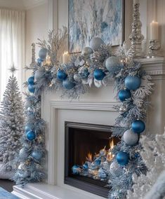 a fireplace decorated with blue and silver ornaments