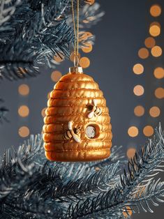 a gold ornament hanging from a christmas tree