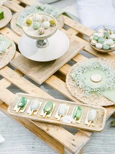 an assortment of desserts on wooden trays at a wedding or baby's first birthday party