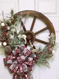 a wreath on the front door with christmas decorations and an old wagon wheel behind it