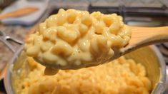 a wooden spoon with macaroni and cheese on it