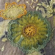 two yellow and green flowers are on the fabric