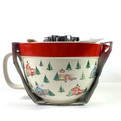 a red and white bowl filled with lots of spoons next to a knife holder