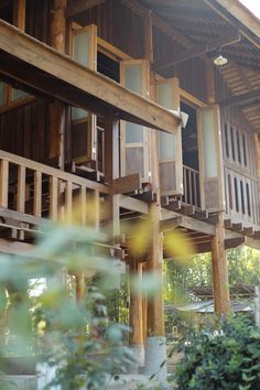 a wooden building with lots of windows and balconies on the second story balcony