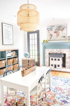 a living room filled with furniture and a fire place under a chandelier over a white table