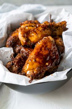 some chicken wings are in a white bowl