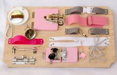 a wooden tray with many different types of sewing tools and accessories on top of it